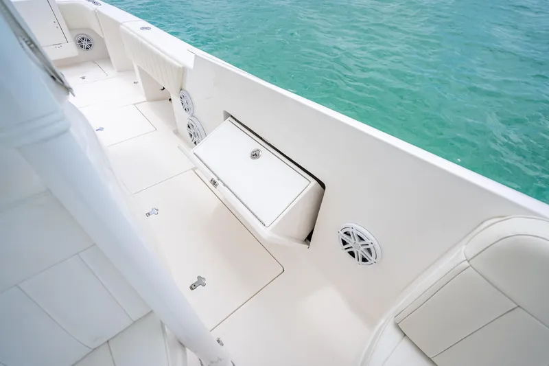 Slide: The Image of 2015 Intrepid 400 Cuddy boat interior with white seating and ocean view. - 31
