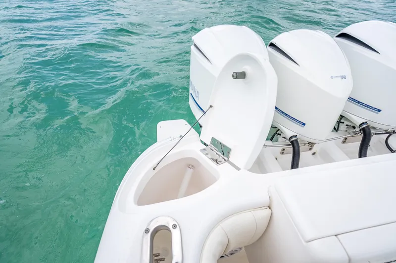 Slide: The Image of 2015 Intrepid 400 Cuddy boat with triple outboard engines on turquoise water. - 38