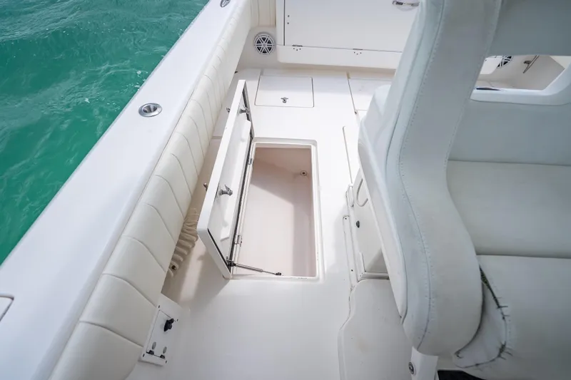 Slide: The Image of 2015 Intrepid 400 Cuddy boat interior with open storage compartment and white seating. - 39
