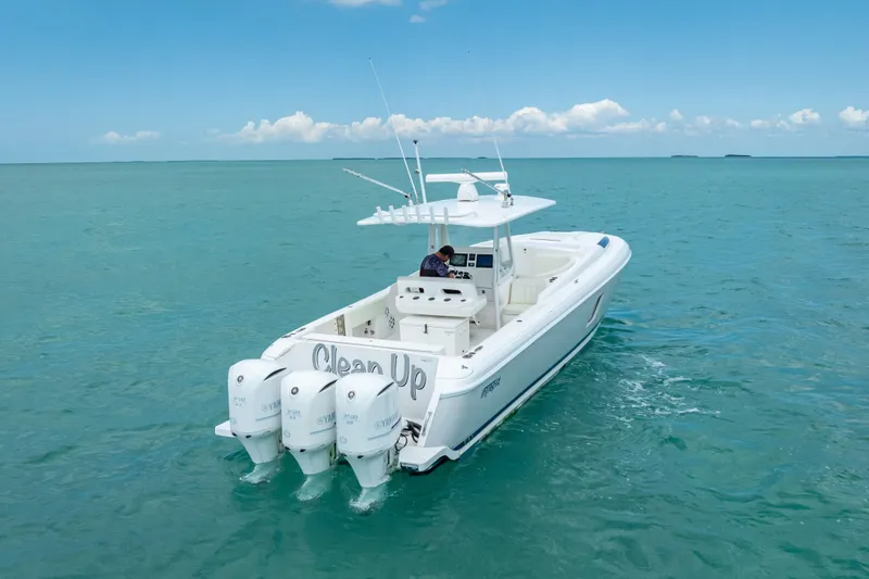 Slide: The Image of 2015 Intrepid 400 Cuddy boat cruising on clear blue ocean waters. - 4