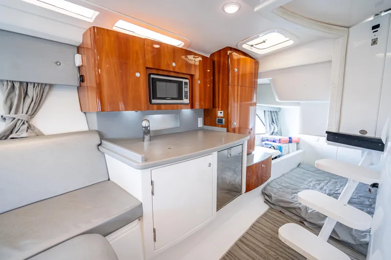 Slide: The Image of Luxurious 2015 Intrepid 400 Cuddy interior with modern kitchenette and cozy seating area. - 40
