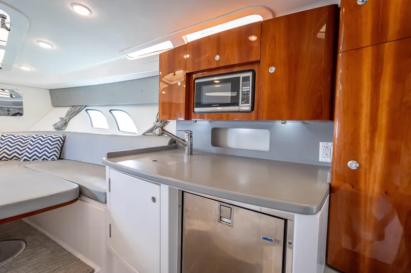 Slide: The Image of Luxurious interior of 2015 Intrepid 400 Cuddy with modern kitchenette and seating area. - 44