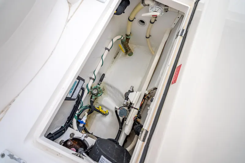 Slide: The Image of Engine compartment of a 2015 Intrepid 400 Cuddy boat, showcasing internal components and wiring. - 49