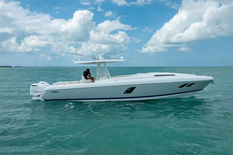 Slide: The Image of 2015 Intrepid 400 Cuddy boat cruising on open water under a blue sky. - 5