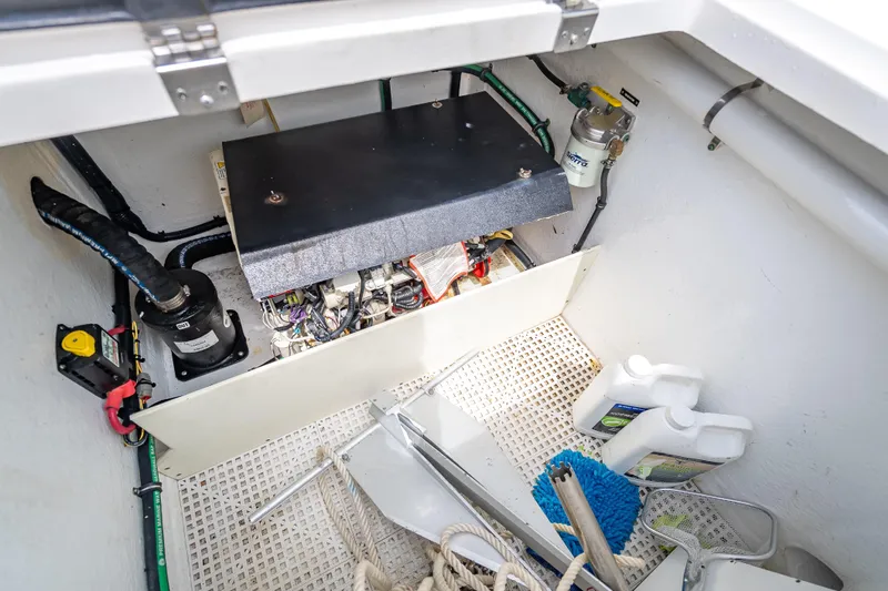 Slide: The Image of Engine compartment of a 2015 Intrepid 400 Cuddy boat with equipment and supplies. - 50