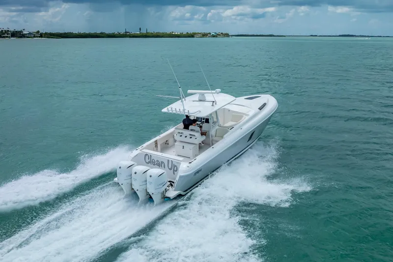 Slide: The Image of 2015 Intrepid 400 Cuddy cruising on open water under cloudy skies. - 9