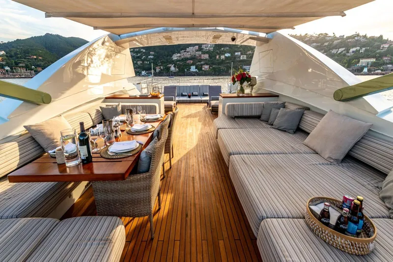 Slide: The Image of Luxurious 2010 Peri Yachts 29M Custom deck with elegant dining setup and scenic views. - 9