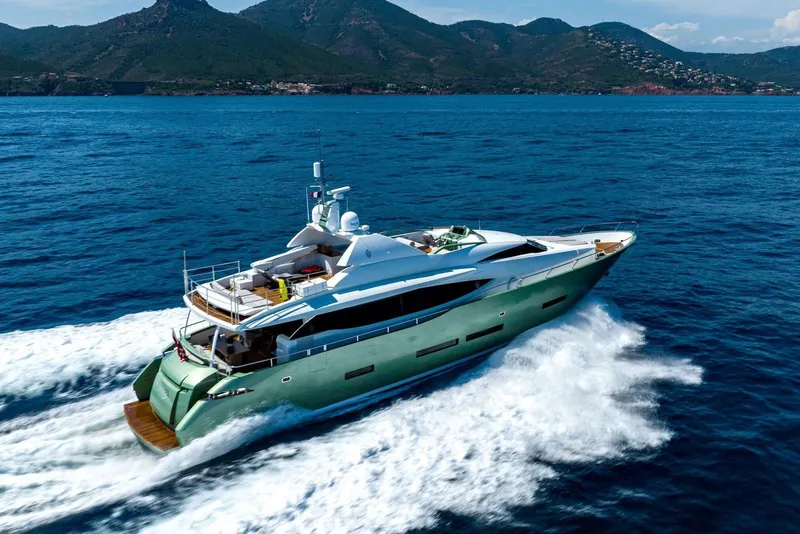 The Image of Luxurious 2010 Peri Yachts 29M Custom cruising on open sea with scenic mountain backdrop. - 0