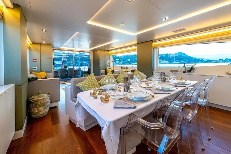 Slide: The Image of Luxurious interior of 2010 Peri Yachts 29M Custom, featuring elegant dining setup and scenic views. - 15