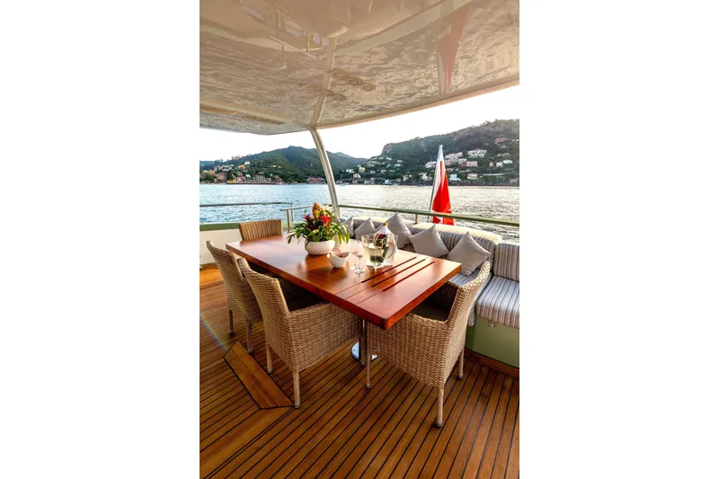 Slide: The Image of Luxurious outdoor dining area on 2010 Peri Yachts 29M Custom, overlooking scenic waterfront. - 10