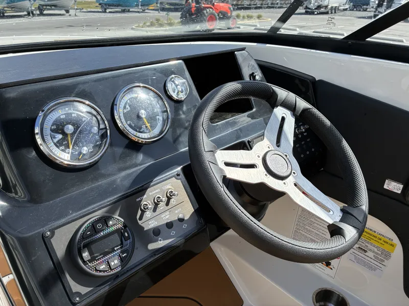 Slide: The Image of Dashboard of Bayliner V20 2026 with steering wheel and gauges. - 13
