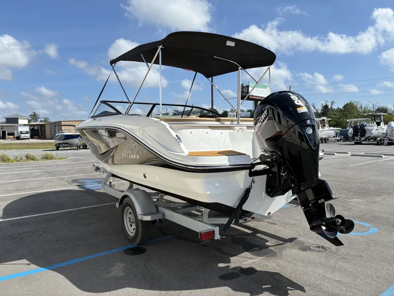Slide: The Image of 2026 Bayliner V20 boat parked outdoors on a trailer. - 5