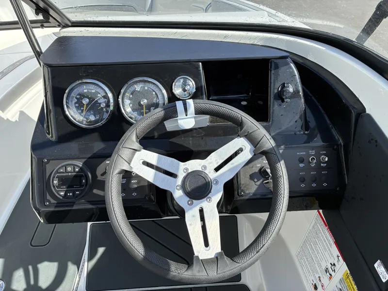 Slide: The Image of Dashboard of Bayliner V20 2026 with steering wheel and gauges. - 12