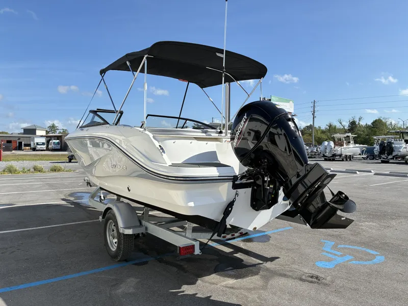 Slide: The Image of Bayliner V20 2026 boat parked on trailer outdoors. - 5
