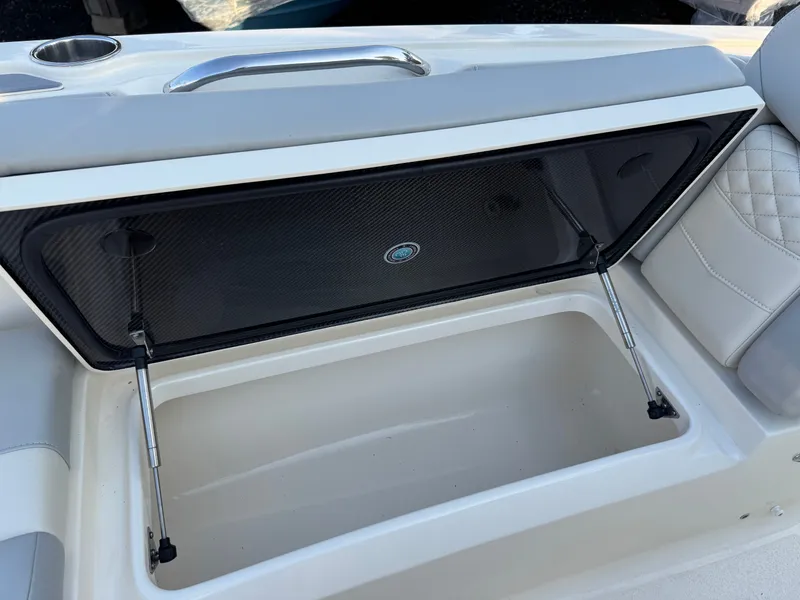 Slide: The Image of 2024 Scout 281 xss Carbon boat with open storage compartment. - 12