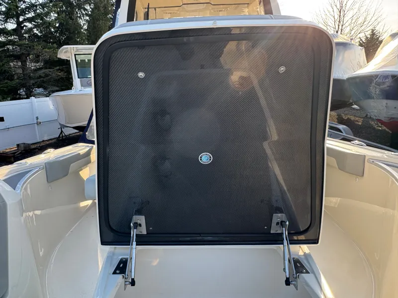 Slide: The Image of 2024 Scout 281 xss Carbon boat with open rear hatch. - 14