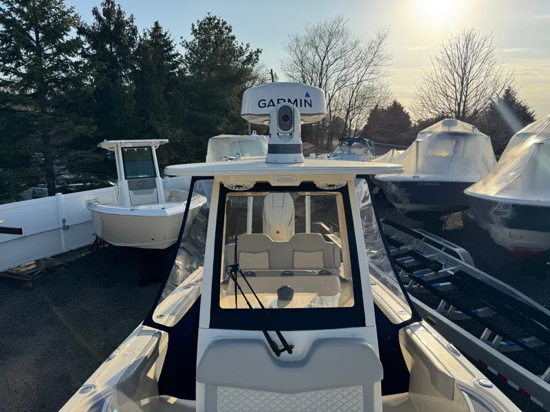 Slide: The Image of 2024 Scout 281 xss Carbon boat with Garmin equipment outdoors. - 8