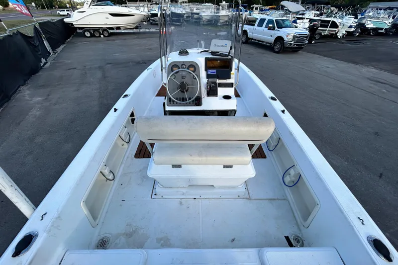Slide: The Image of 1999 Hydra-Sports 2000 CC boat interior with console and seating, parked in marina. - 12
