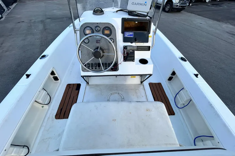 Slide: The Image of 1999 Hydra-Sports 2000 CC boat cockpit with steering wheel and Garmin navigation system. - 14