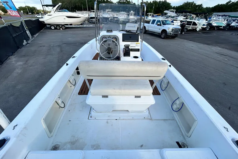 Slide: The Image of 1999 Hydra-Sports 2000 CC boat interior with steering console and seating, parked in marina. - 15