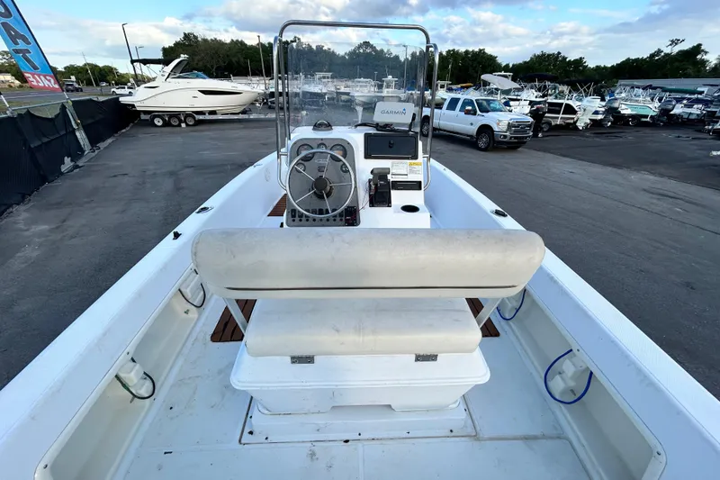 Slide: The Image of 1999 Hydra-Sports 2000 CC boat interior with steering console and seating, parked in a marina. - 16