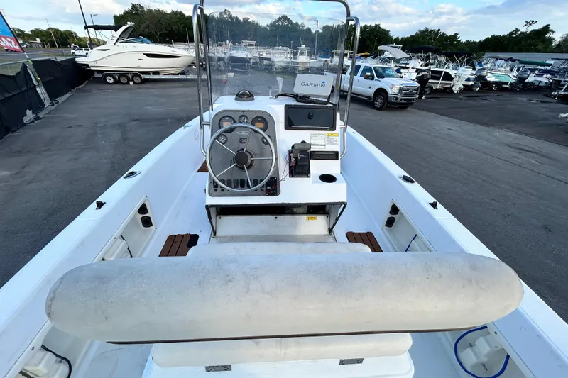 Slide: The Image of 1999 Hydra-Sports 2000 CC boat interior with steering console, docked among other boats. - 17