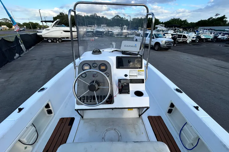 Slide: The Image of 1999 Hydra-Sports 2000 CC boat dashboard with Garmin navigation, parked in a marina. - 18