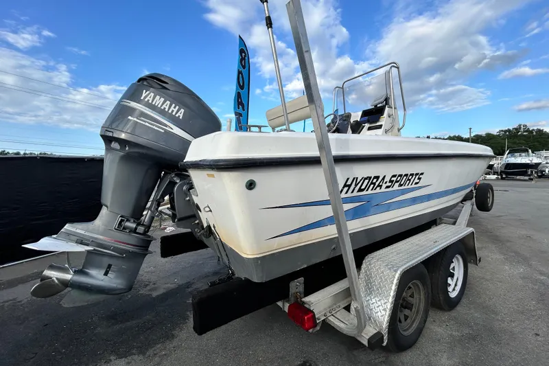Slide: The Image of 1999 Hydra-Sports 2000 CC boat with Yamaha outboard motor on trailer under blue sky. - 2
