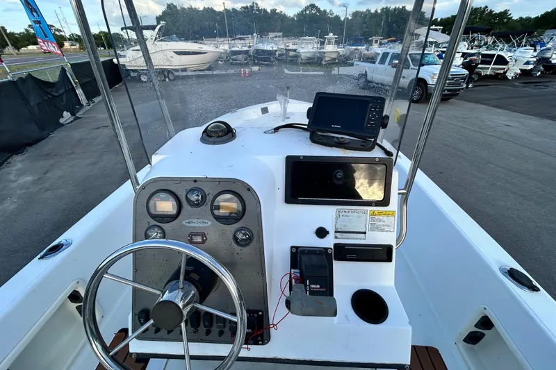 Slide: The Image of 1999 Hydra-Sports 2000 CC boat dashboard with steering wheel and navigation equipment. - 20