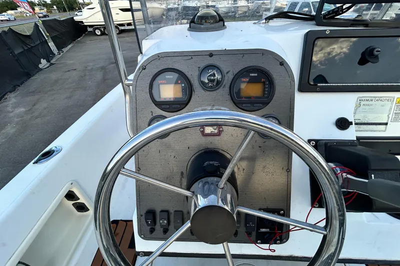 Slide: The Image of 1999 Hydra-Sports 2000 CC boat dashboard with steering wheel and gauges. - 21