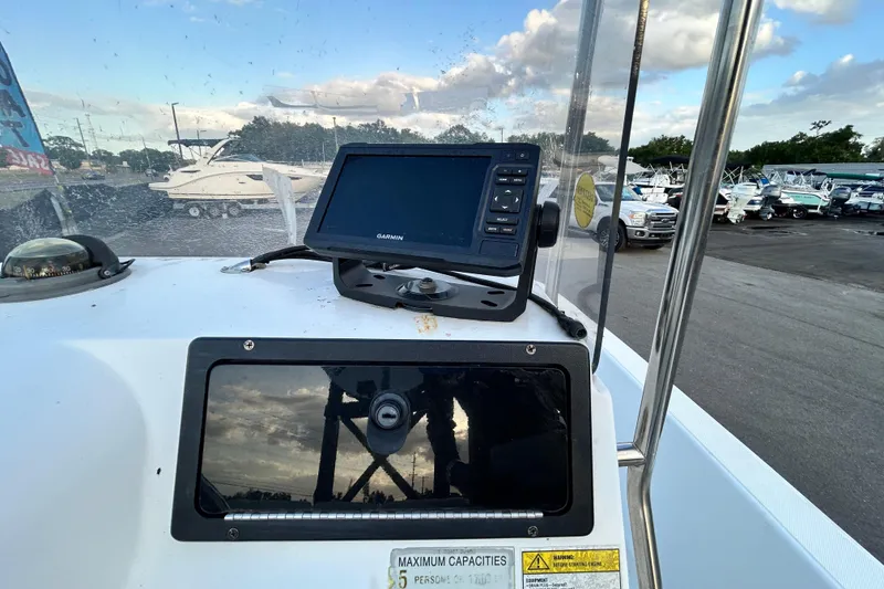 Slide: The Image of 1999 Hydra-Sports 2000 CC boat dashboard with Garmin GPS and compass. - 23