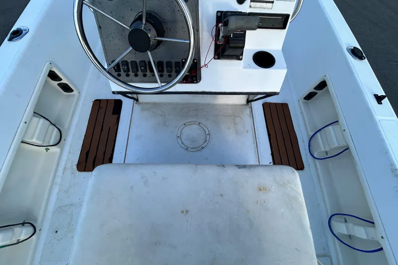 Slide: The Image of 1999 Hydra-Sports 2000 CC boat cockpit with steering wheel and control panel. - 26