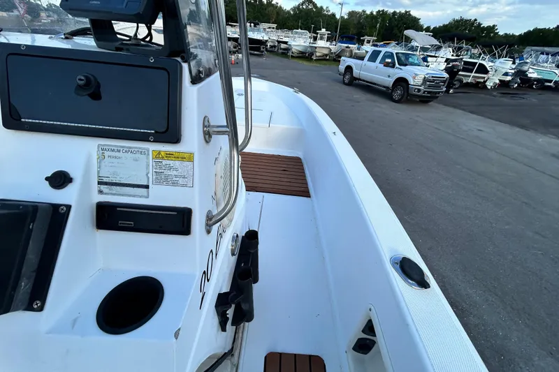 Slide: The Image of 1999 Hydra-Sports 2000 CC boat interior with docked trucks and boats in the background. - 28