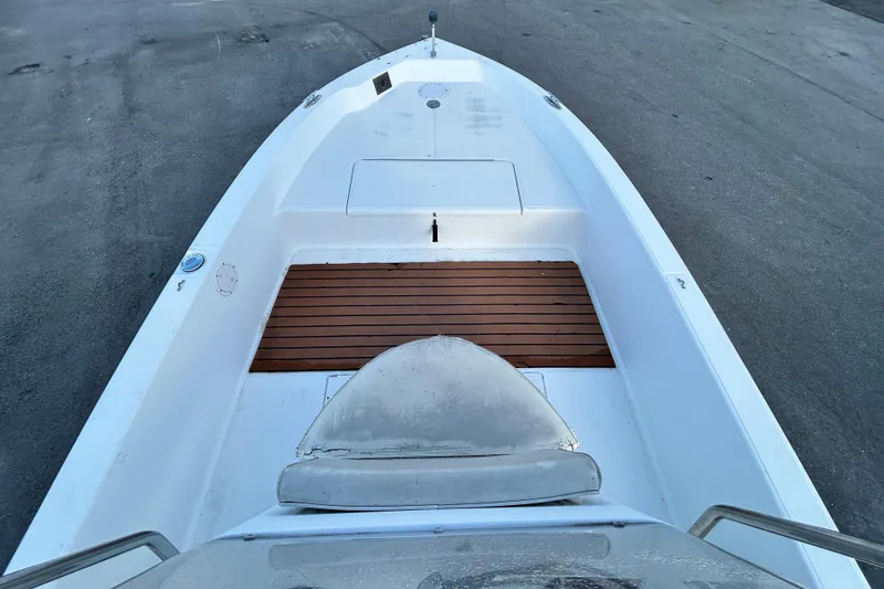 Slide: The Image of 1999 Hydra-Sports 2000 CC boat deck with wooden flooring and seating area. - 29