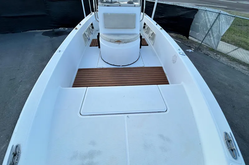 Slide: The Image of 1999 Hydra-Sports 2000 CC boat deck with wooden flooring and central console. - 36