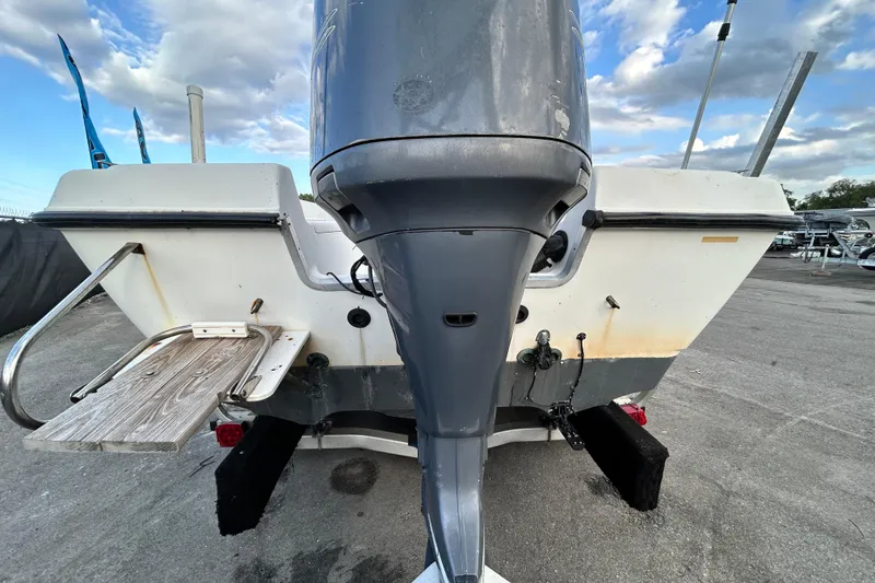 Slide: The Image of 1999 Hydra-Sports 2000 CC boat rear view with outboard motor and swim platform. - 4