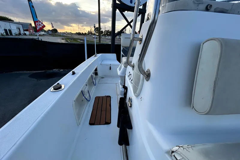 Slide: The Image of 1999 Hydra-Sports 2000 CC boat interior, showcasing seating and deck details at sunset. - 41