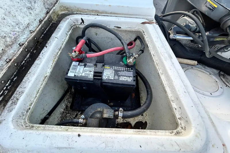 Slide: The Image of Battery compartment of a 1999 Hydra-Sports 2000 CC boat, showing wiring and connections. - 49