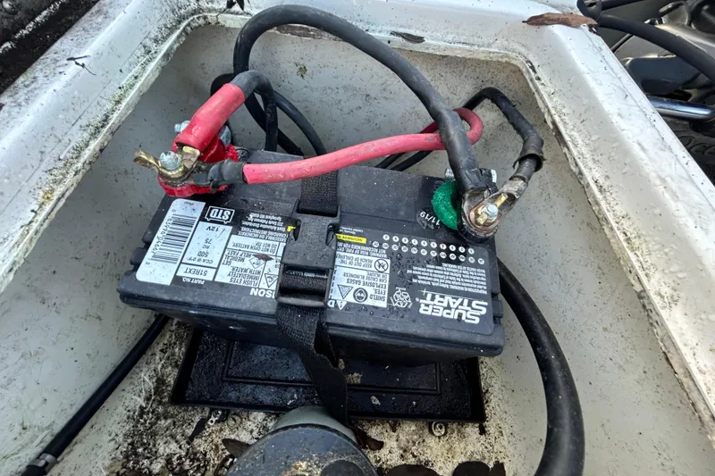 Slide: The Image of Battery compartment of a 1999 Hydra-Sports 2000 CC boat with connected cables. - 50