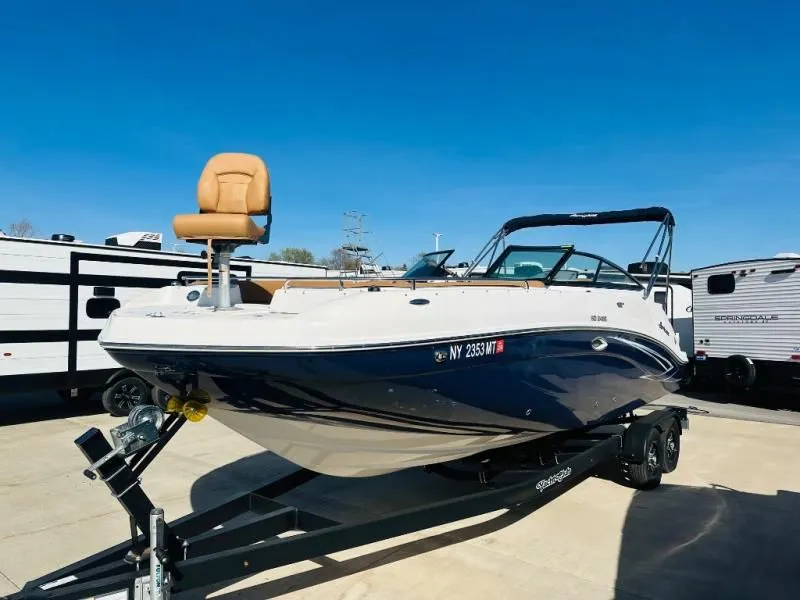 Slide: The Image of 2022 Hurricane SD2486 boat on trailer, blue sky. - 11