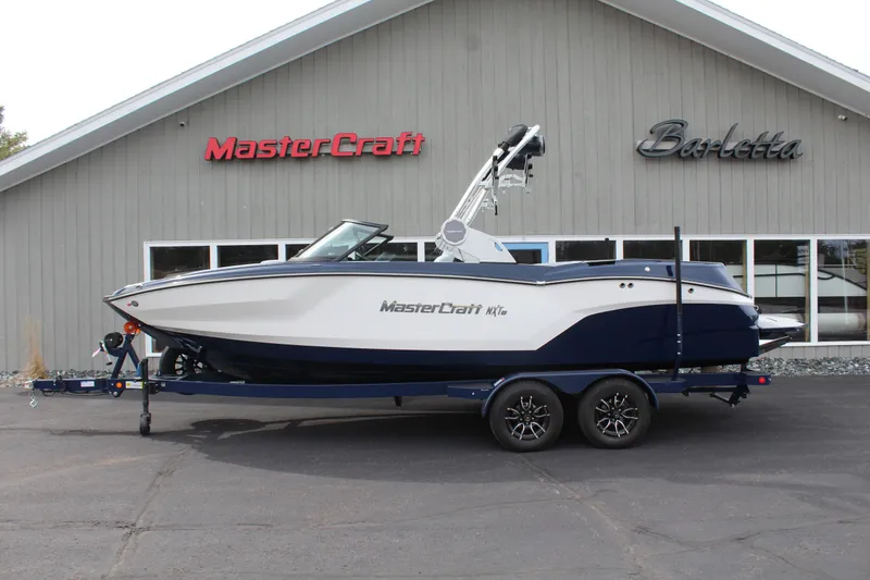 The Image of 2026 MasterCraft NXT23 boat in front of a showroom. - 1