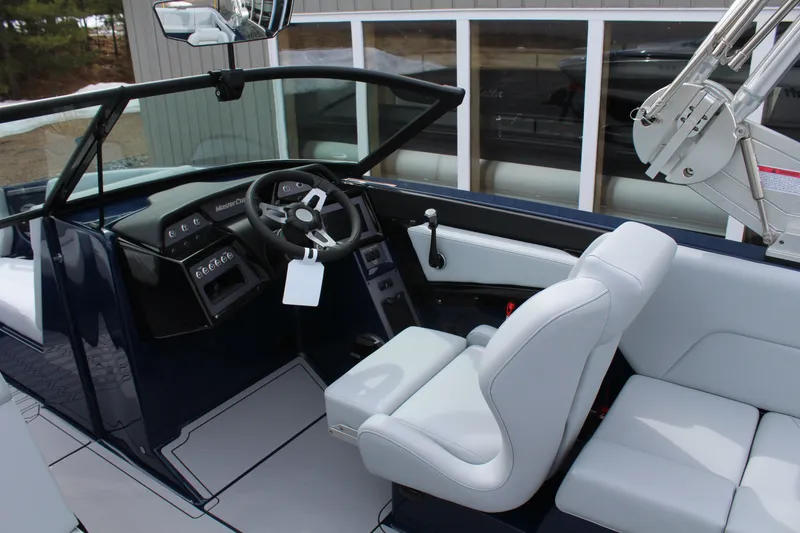 Slide: The Image of Interior of 2026 MasterCraft NXT23 boat with modern cockpit design. - 11