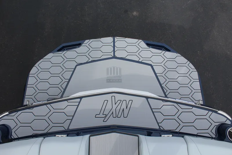 Slide: The Image of Top view of 2026 MasterCraft NXT23 boat deck with hexagonal pattern. - 21