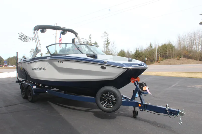 Slide: The Image of 2026 MasterCraft NXT23 boat on trailer, ready for adventure. - 4