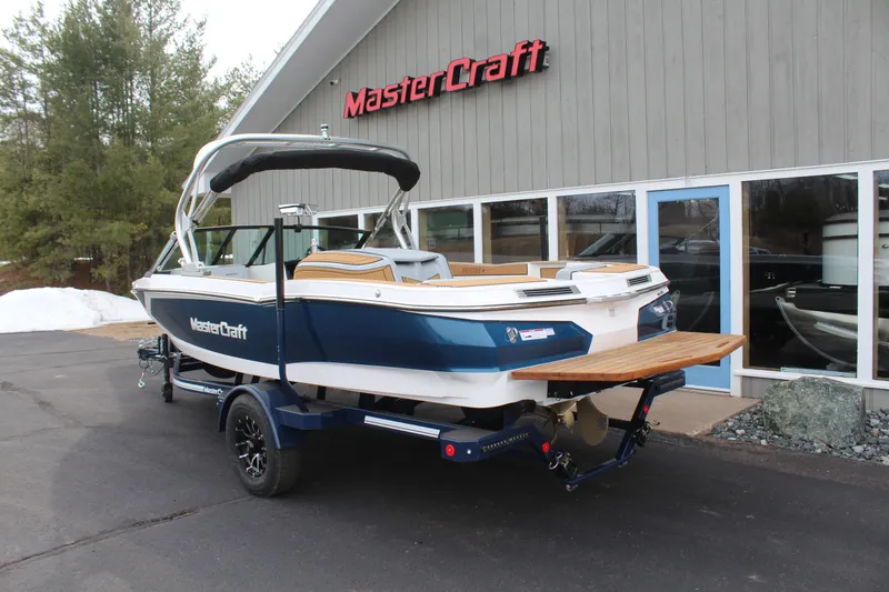 Slide: The Image of 2026 MasterCraft ProStar boat outside a showroom. - 10