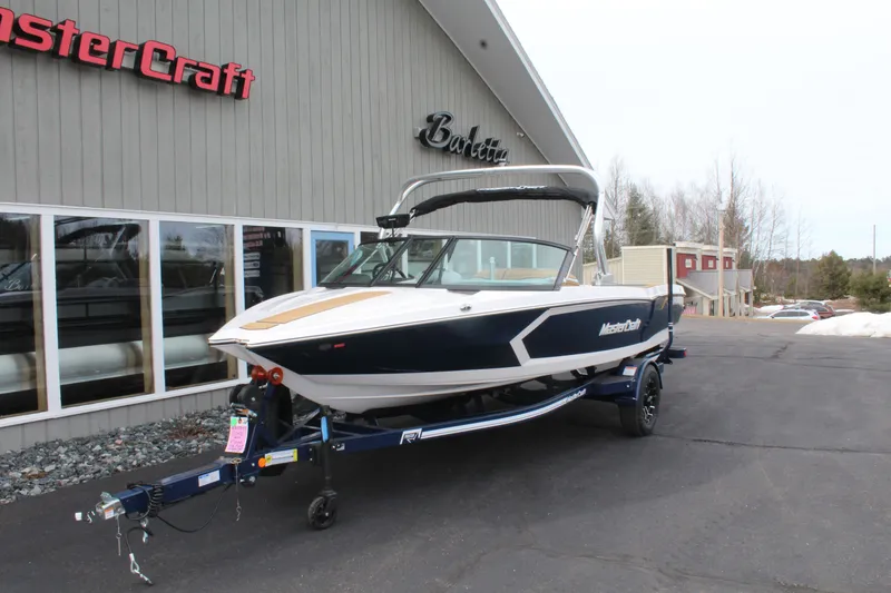 Slide: The Image of 2026 MasterCraft ProStar boat outside a showroom. - 5