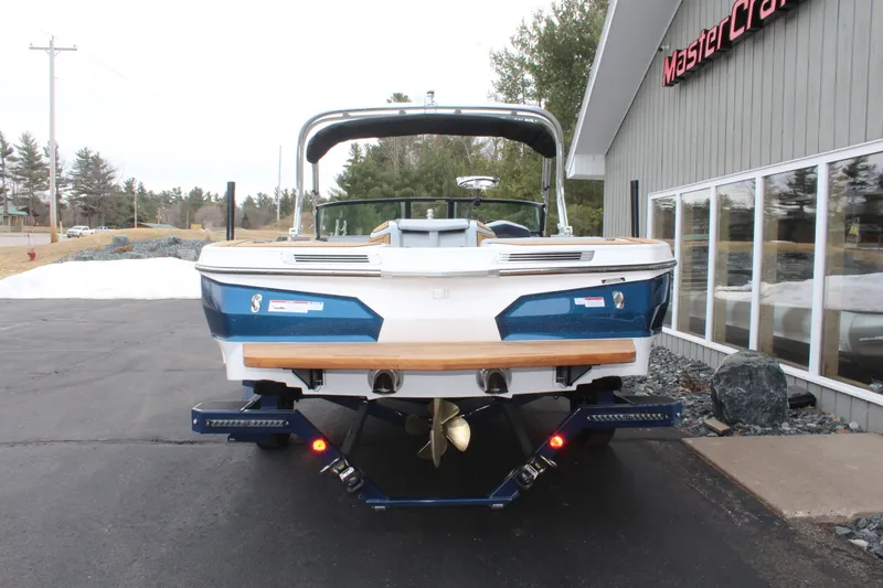 Slide: The Image of Rear view of a 2026 MasterCraft ProStar boat on a trailer. - 9