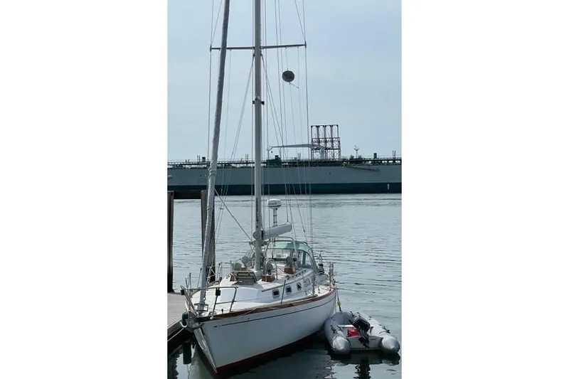 Slide: The Image of 1983 Bristol 38.8 sailboat docked with inflatable dinghy alongside. - 11