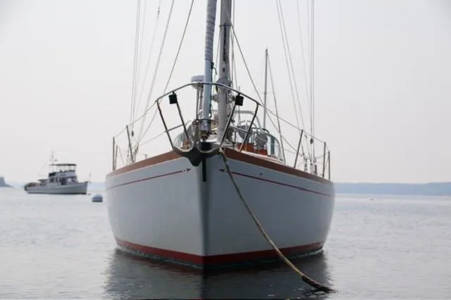 Slide: The Image of 1983 Bristol 38.8 sailboat anchored on calm water, front view. - 12