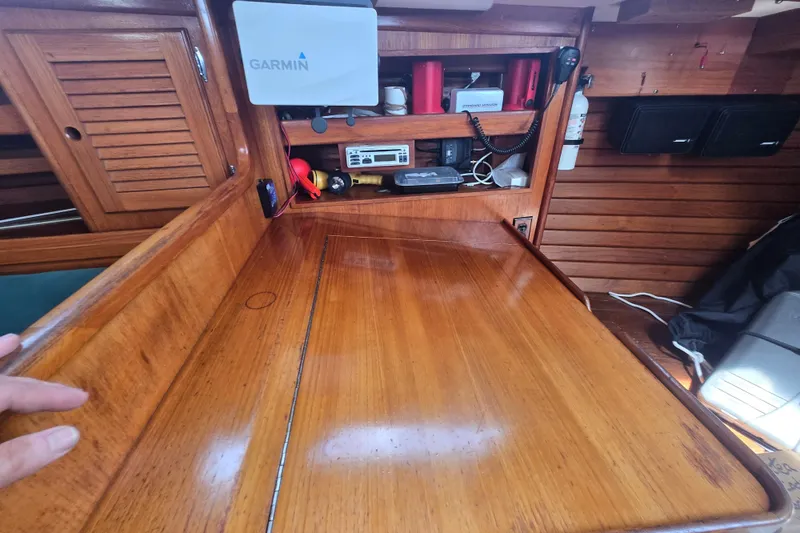 Slide: The Image of Interior of a 1983 Bristol 38.8 sailboat with wooden navigation station and Garmin equipment. - 20